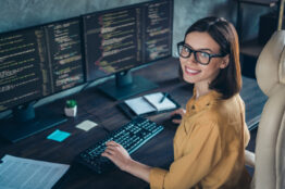 Profile side view portrait of attractive cheerful skilled girl geek developing web site cyber security at workplace workstation indoors
